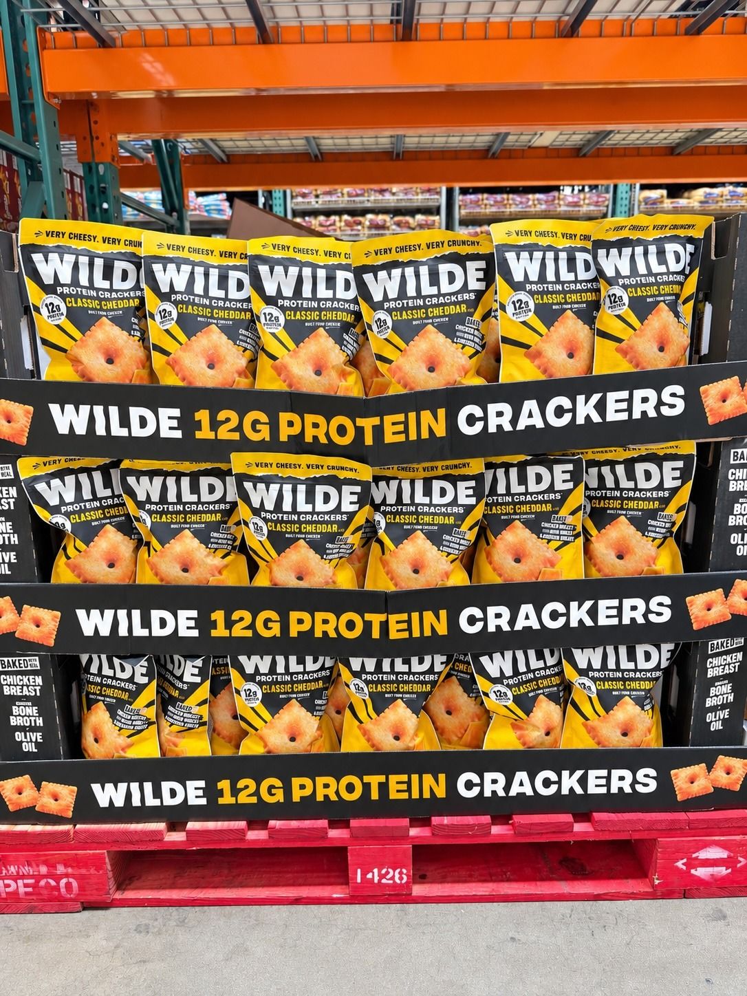 Display of Wilde 12G protein crackers stacked in a store.