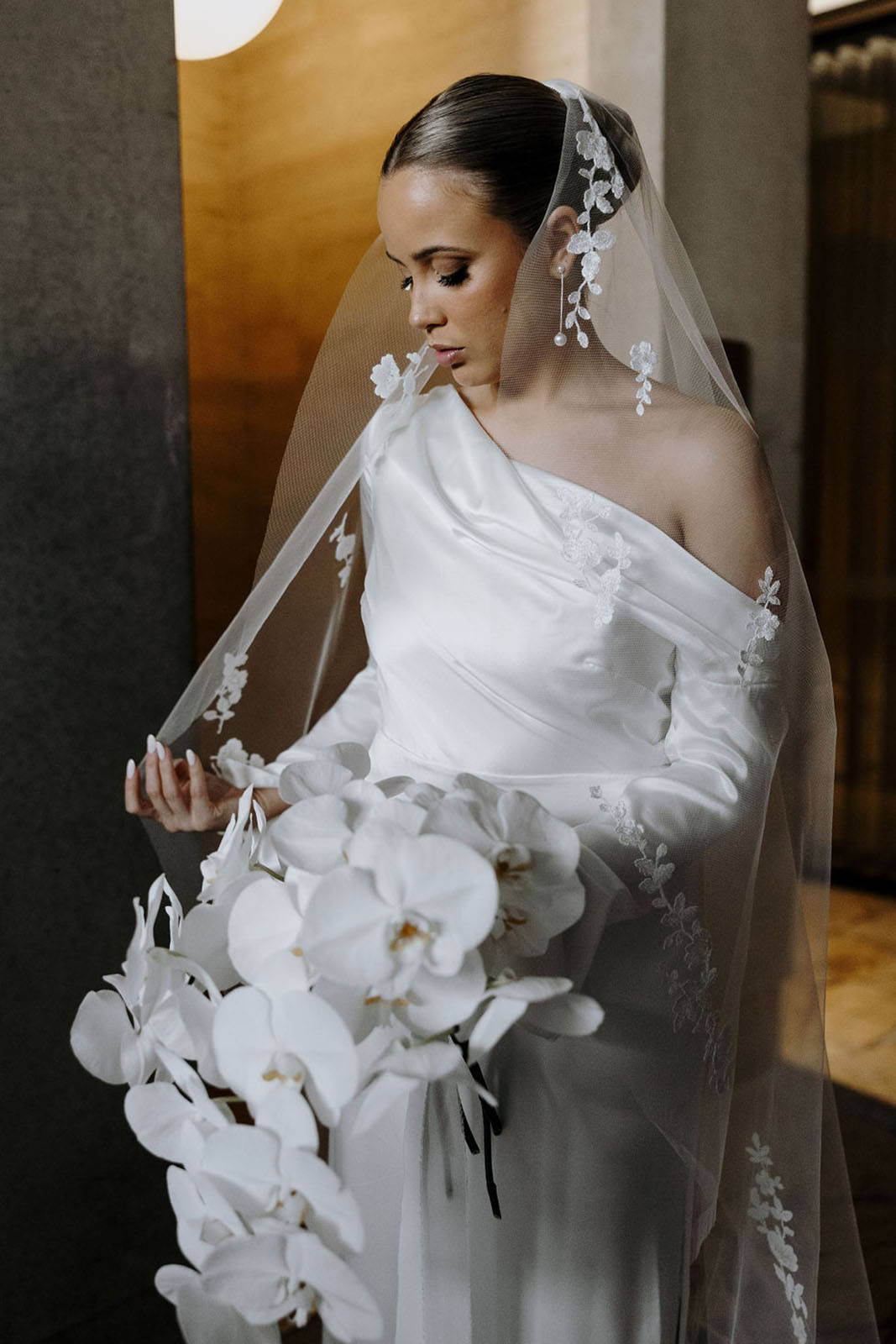 Bride holding qhite floral bouquet
