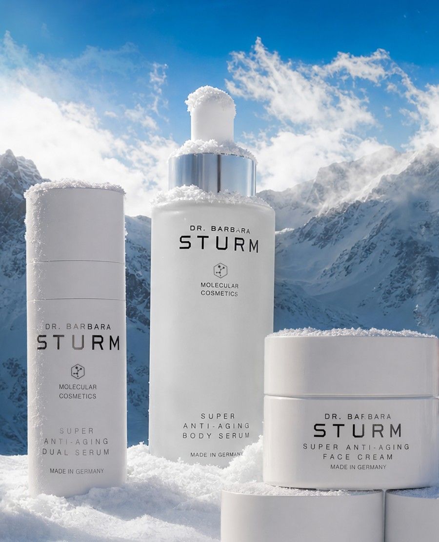 Skincare products from Dr. Barbara Sturm on a snowy mountain backdrop.