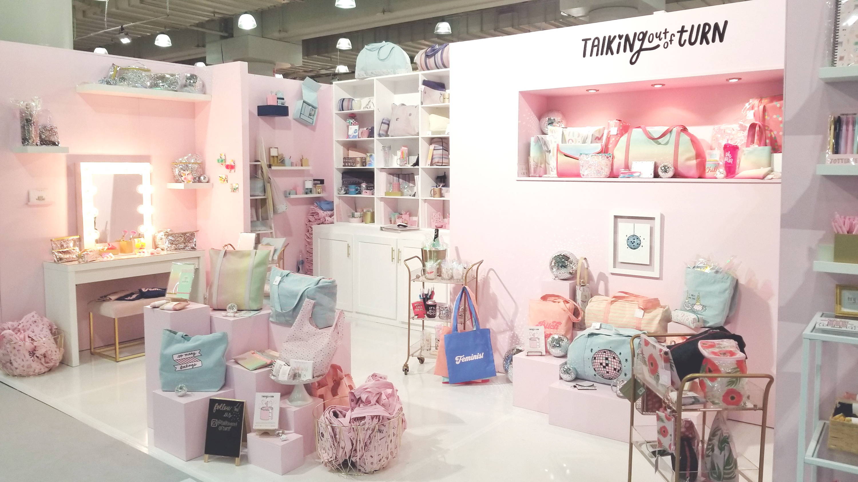 Cute tradeshow booth filled with Toot products like cute tote bags, pencil pouches, and more!