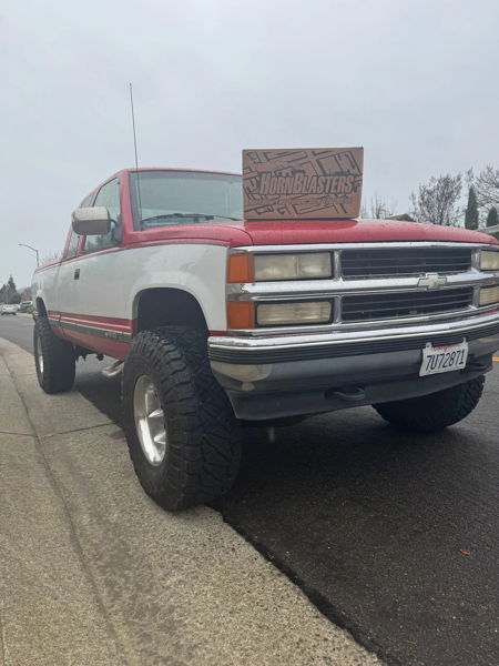 Front three-quarter Kevin's red and white 1994 Chevy Silverado with HornBlasters box on roof photo 1