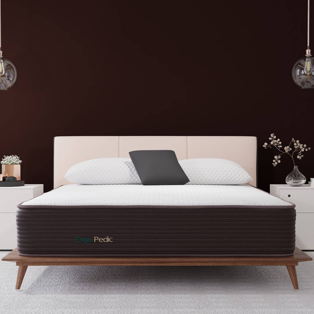 CopperCloud Hybrid mattress in a bedroom with burnt copper walls, and white nightstands. The mattress has a dark border and a white cover.