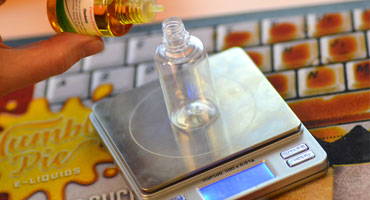 E-Liquid bottle on scales with mixing concentrate