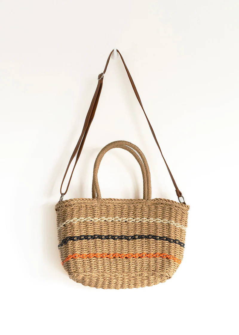  wicker basketed with white, black and orange  stripes and a leather shoulder strap
