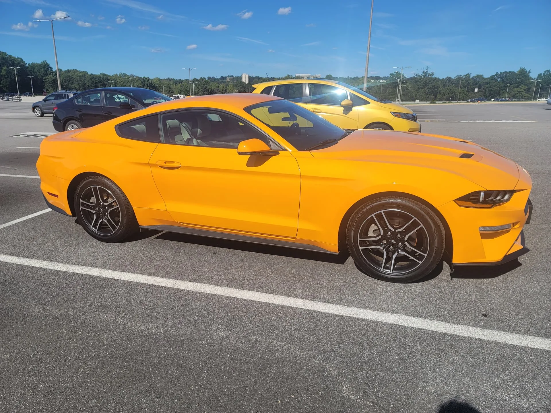 Orange Ford Mustang front three-quarter exterior view