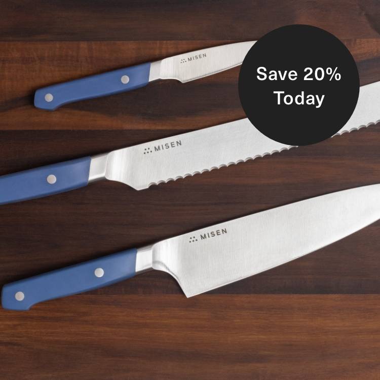 Misen Chef’s, Serrated, and Paring Knives seen from above on a dark wood cutting board, with a badge calling out 20% savings.