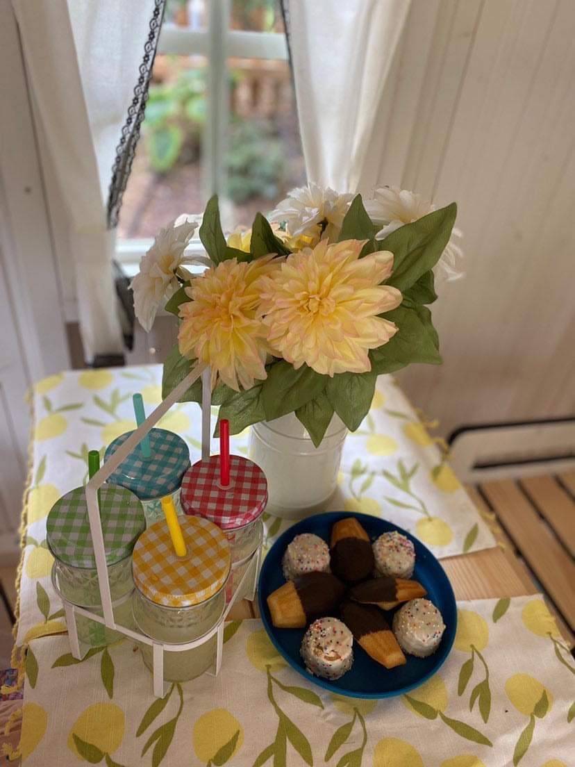 Close Up Of The kids table with flowers, lemonade and cupcakes inside Of Kids Wooden Playhouse Arctic Nario by WholeWoodPlayhouses 