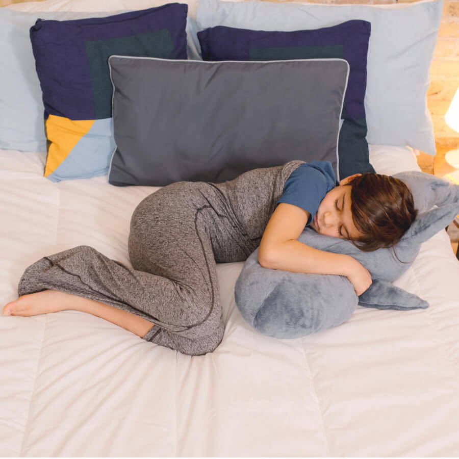 image of child in sleep pod sleeping on bed