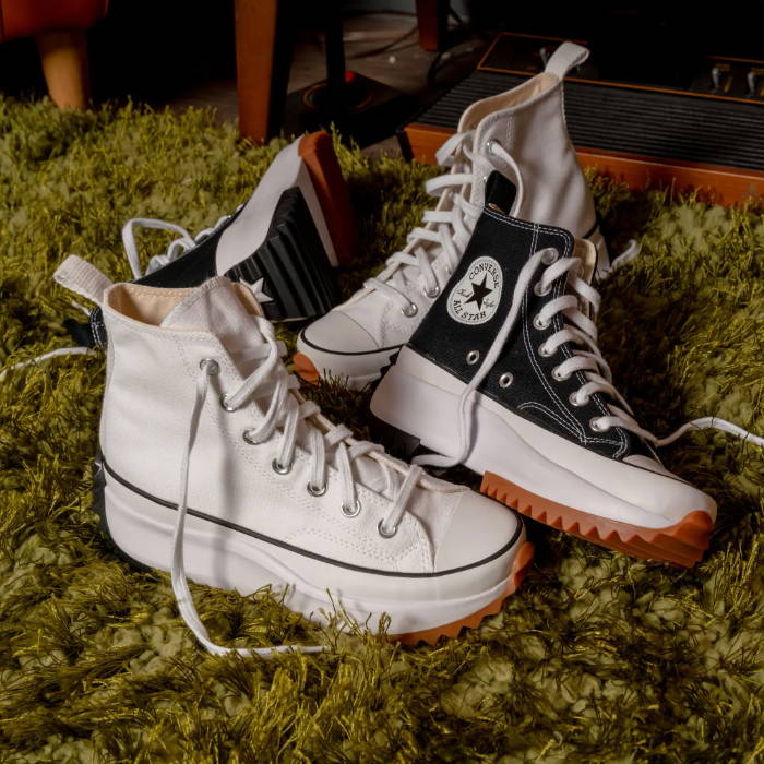 black and white high top converse on carpet