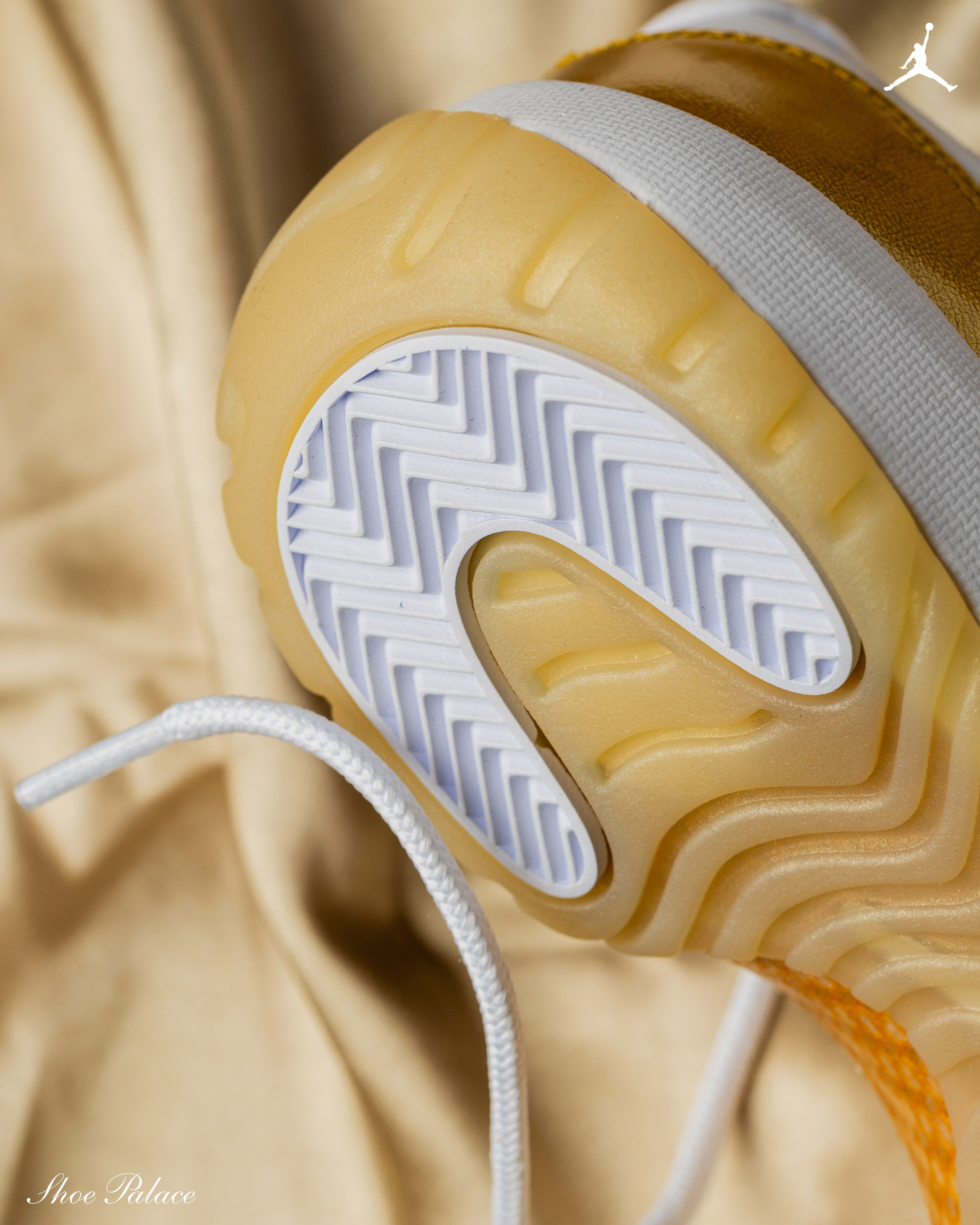 Close-up of sneaker sole with textured pattern on a soft background.