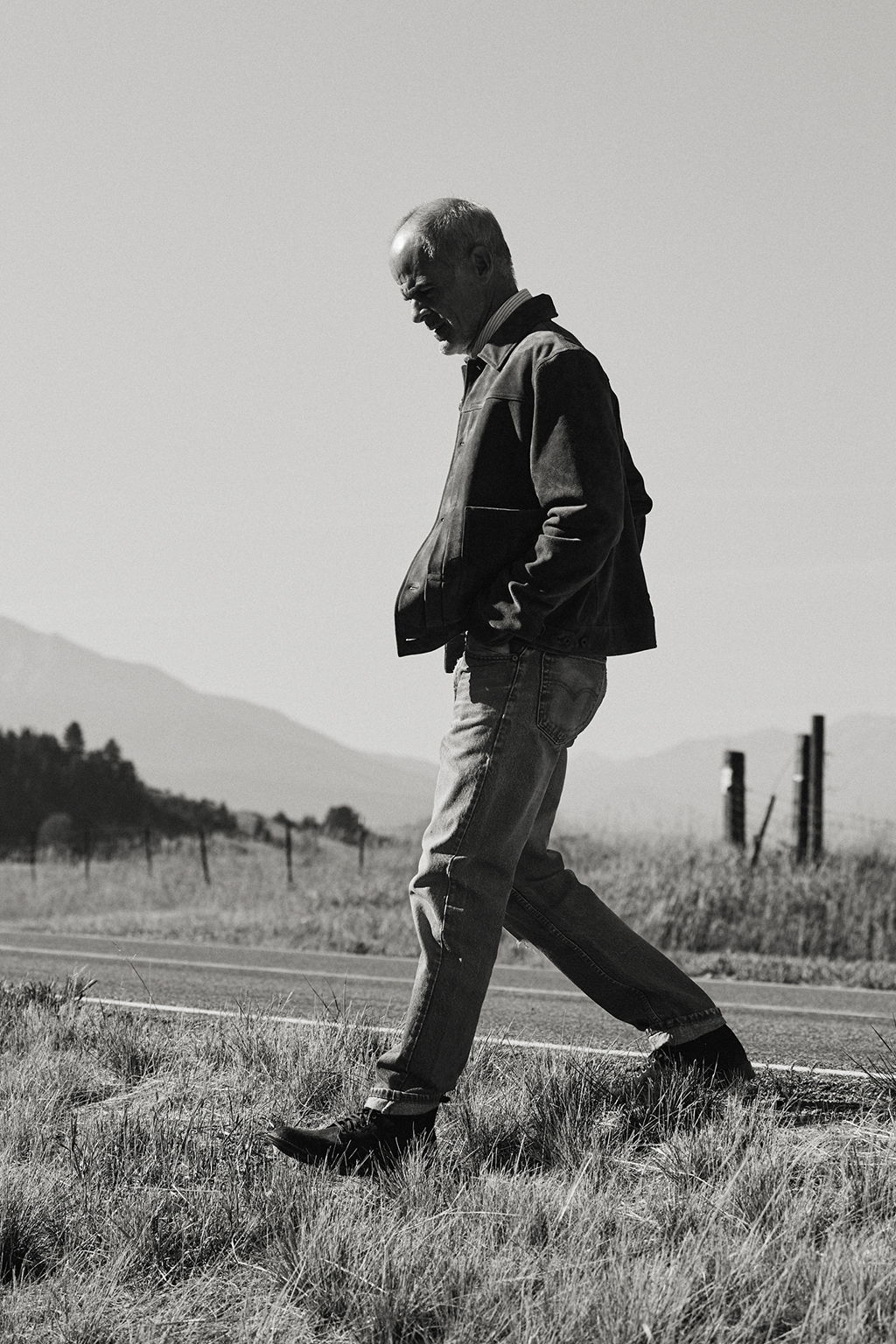 Black and White photograph of Michael Kelly crossing the road outside of Livingston, Montana