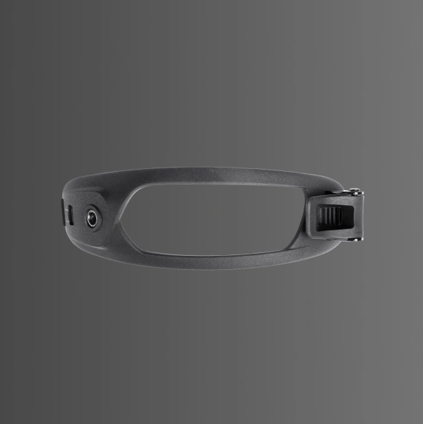 Black object with a loop and adjustable strap, set against a dark background.