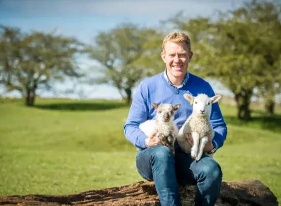 Adam Henson with 2 lambs 