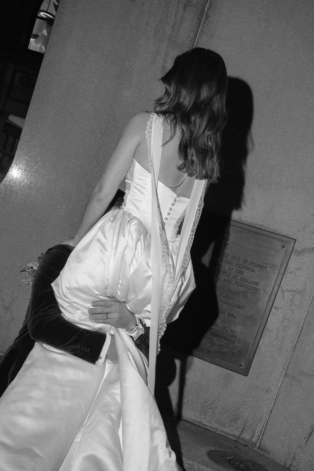 A woman in a white dress is being lifted by a person.