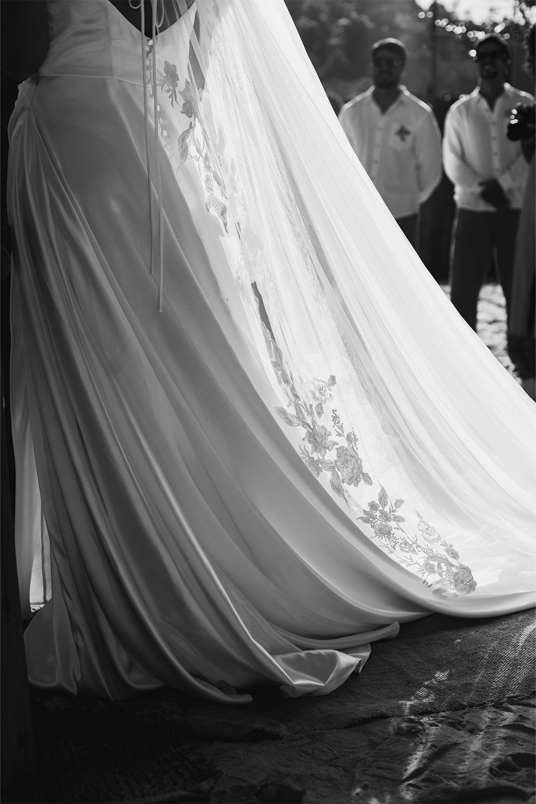 A close-up of a wedding dress with intricate embroidery.