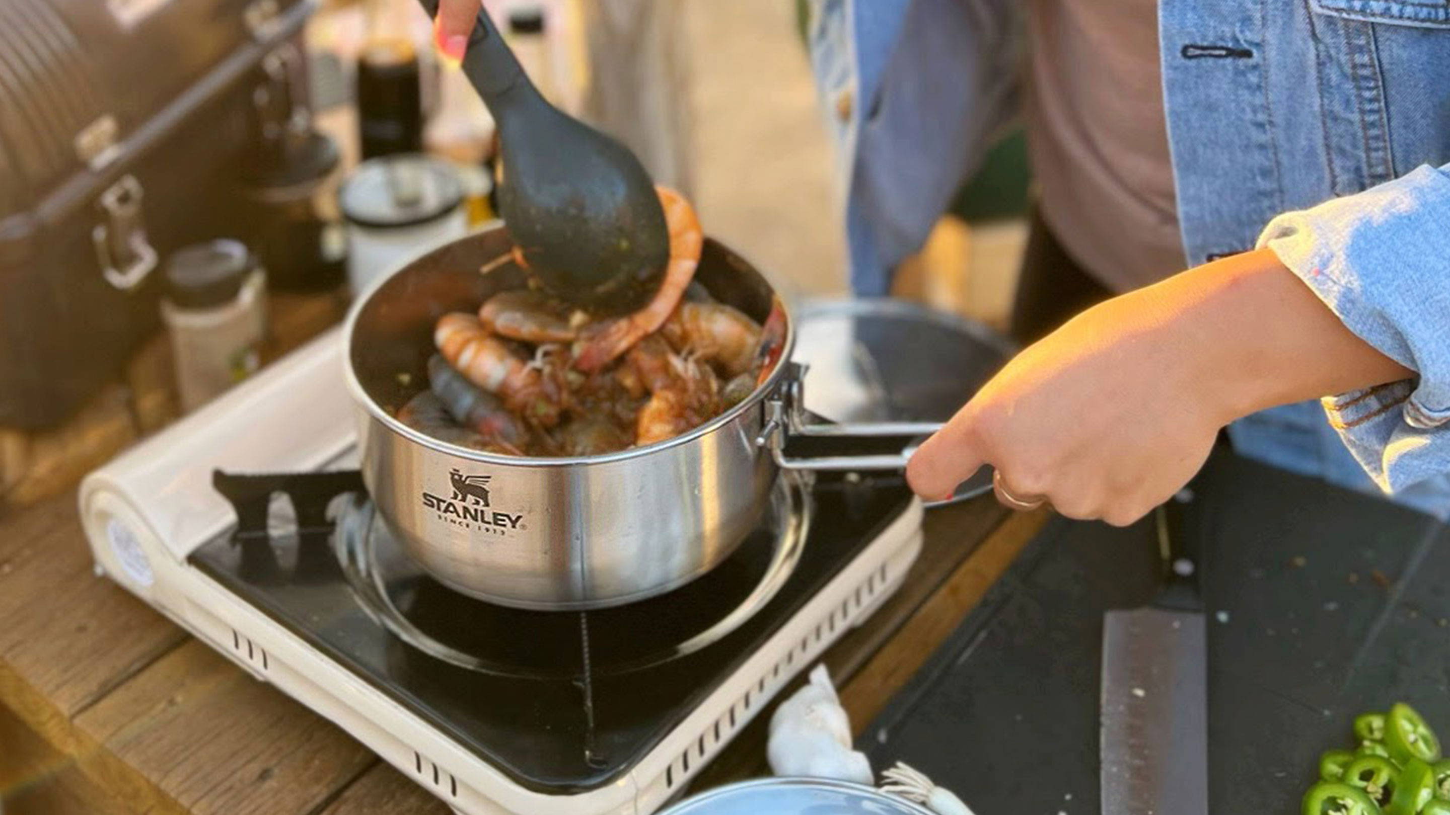 Chef Stephanie Tea cooks shrimp in Stanley’s stainless-steel sauce pan on a camp stove.