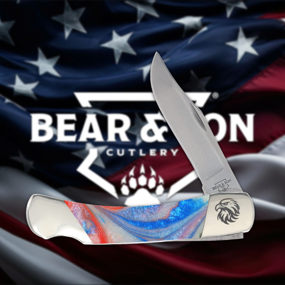 Knife with a colorful handle against a flag backdrop and brand logo.