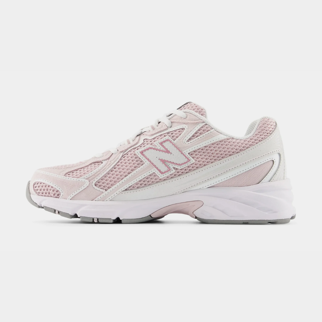 Light pink New Balance sneakers with mesh design and white accents.