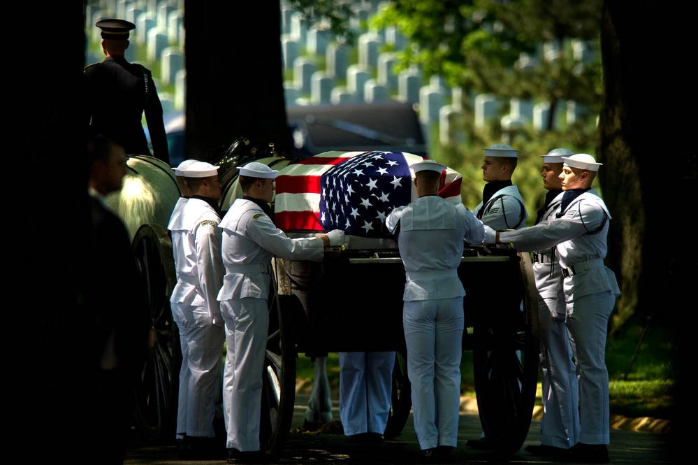 Members of the U.S. Navy Ceremonial Guard take the casket of a sailor killed during the Vietnam War to his gravesite at Arlington National Cemetery. Lt. Dennis Peterson, from Huntington Park, Calif.; Ensign Donald Frye, from Los Angeles; and Aviation Antisubmarine Warfare Technicians 2nd Class William Jackson, from Stockdale, Texas, and Donald McGrane, from Waverly, Iowa, all four assigned to Helicopter Squadron (HS) 2, were killed when their SH-3A Sea King helicopter was shot down July 19, 1967 over Ha Nam Province, North Vietnam. (U.S. Navy photo by Mass Communication Specialist 2nd Class Todd Frantom/Released)