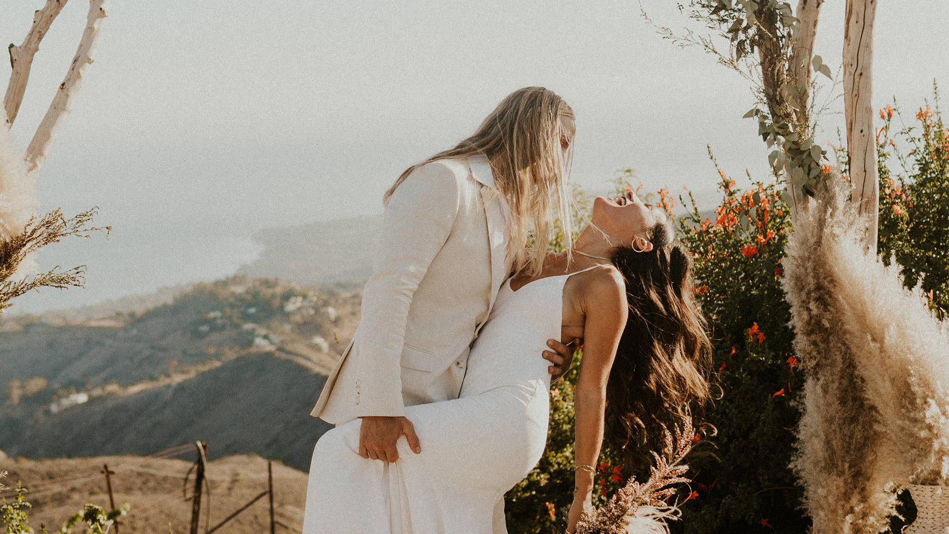 Groom wearing a cream cuit with his new wife in a silk gown