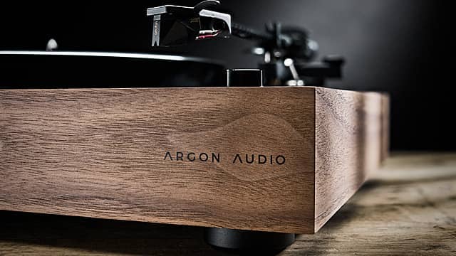 A close up of a turntable plinth with branding.