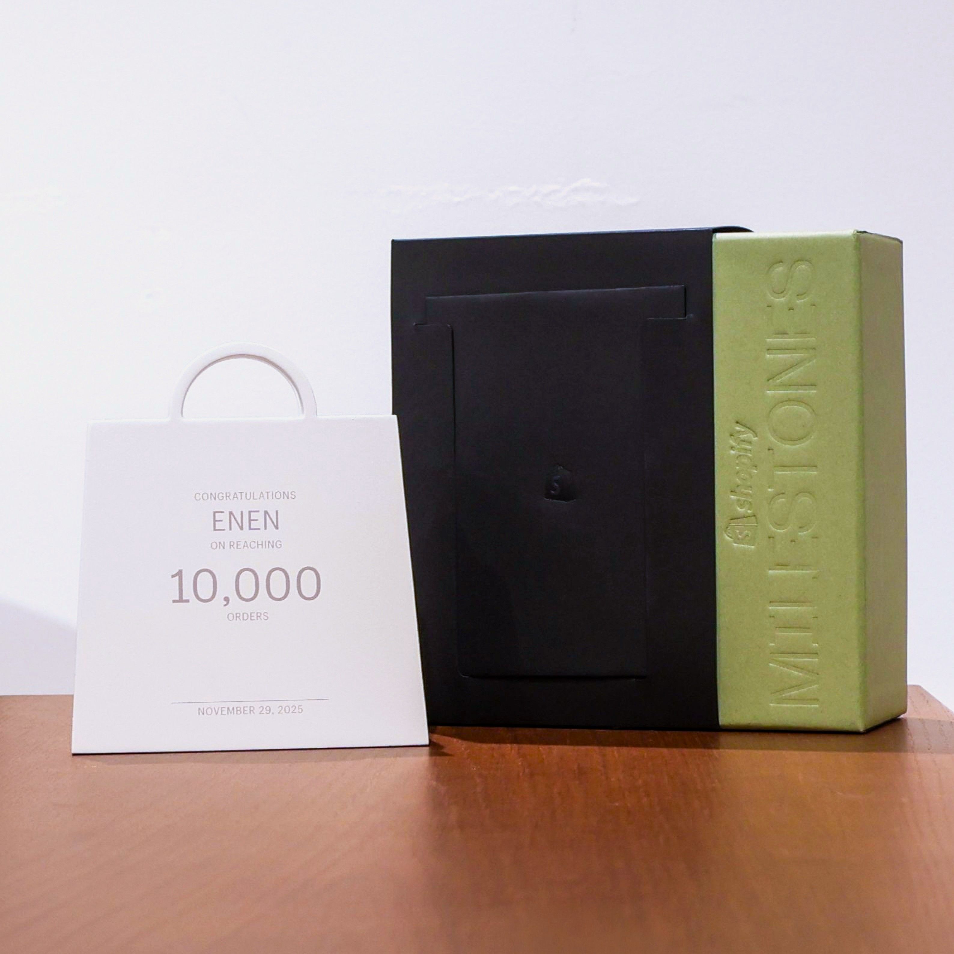 A black box beside a white bag displaying 