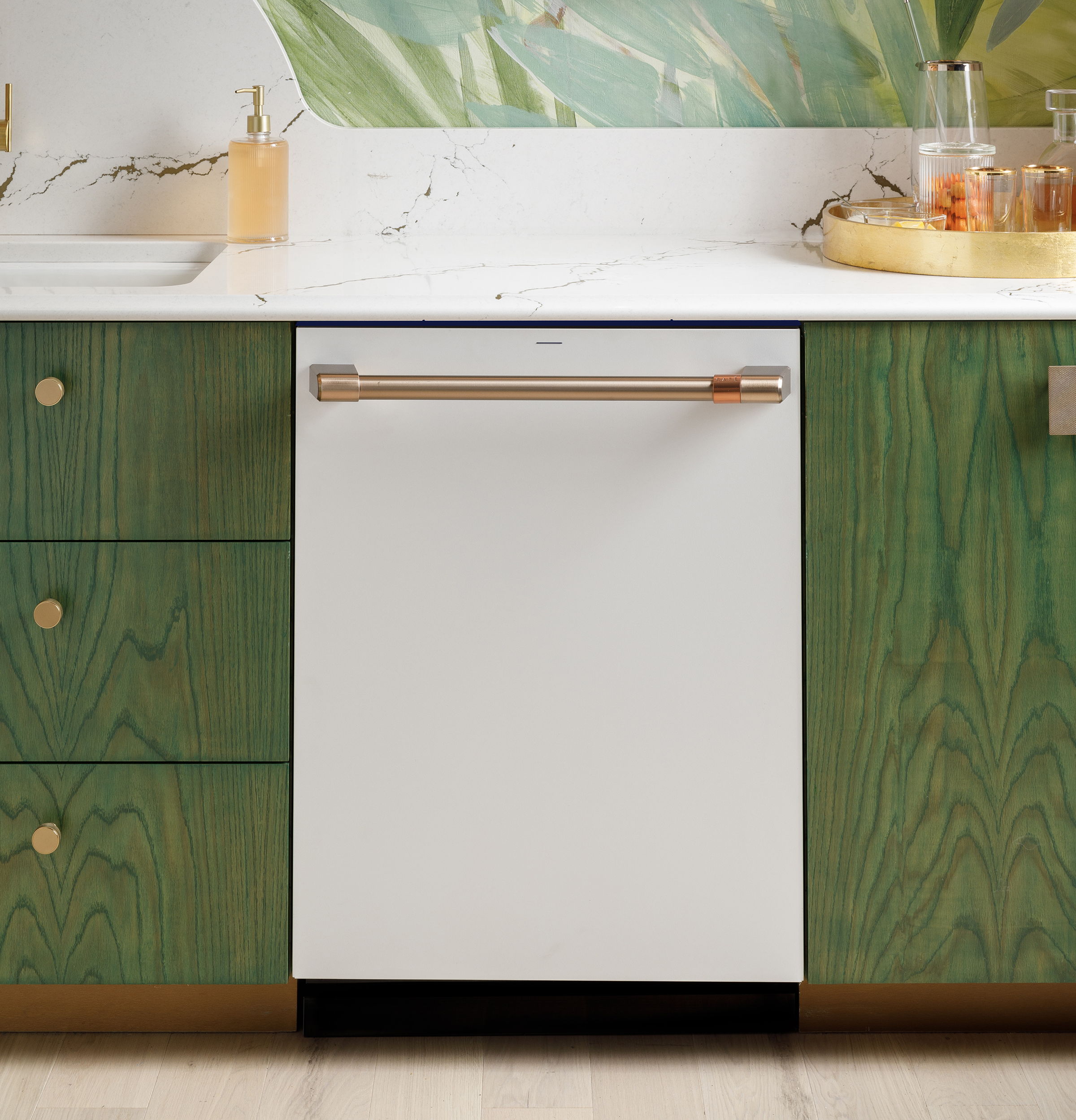 White dishwasher in a modern kitchen with green cabinets and a countertop.