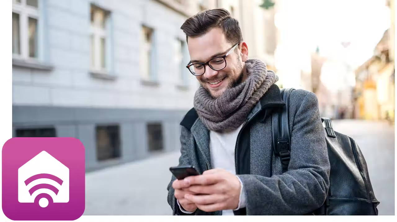 Young millennial man using the SmartHQ app on his mobile phone. 