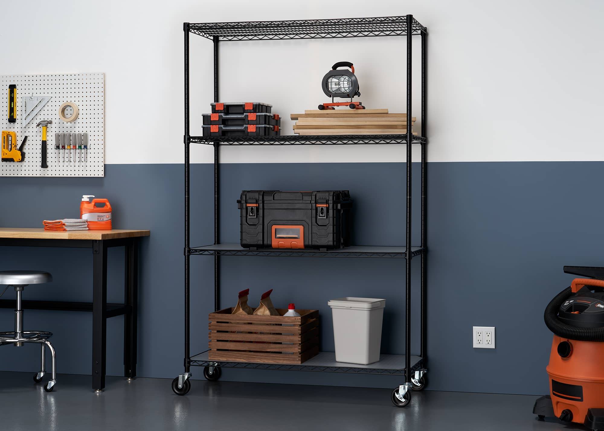 black wire shelving rack in a garage filled with wood working tools and materials