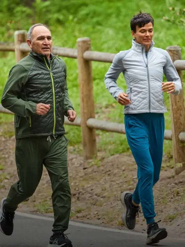 man and woman runners wearing Nathan Sport Navigator Hybrid Jackets