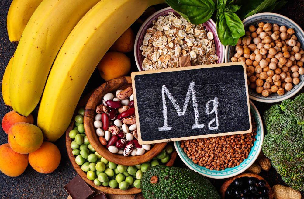 table full of magnesium rich foods with Mg chalkboard|magnesim is essential for enhanced fitness better sleep improved mood