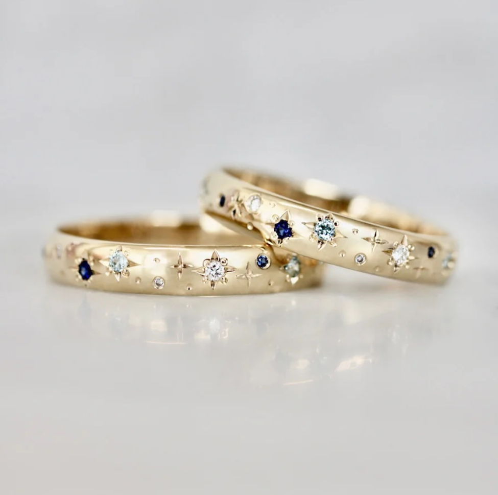 Hand-engraved star wedding bands with diamonds and sapphire