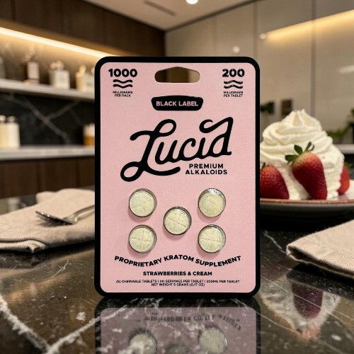 Lucid gummy supplements on a table with dessert in the background.
