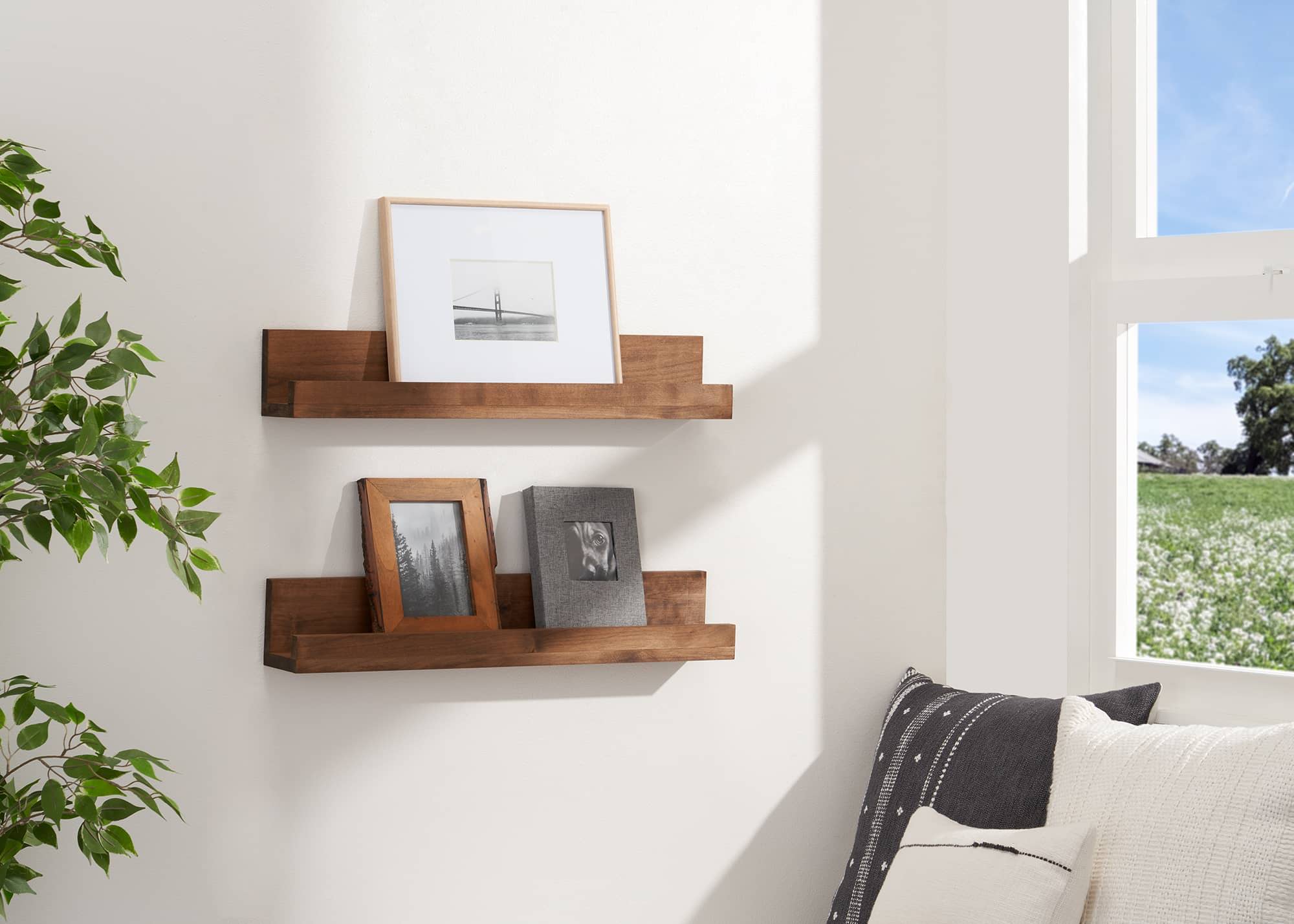 2 floating shelf filled with pictures frames
