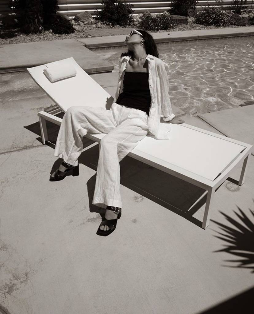 Laura Angelone wearing white wide leg linen trousers