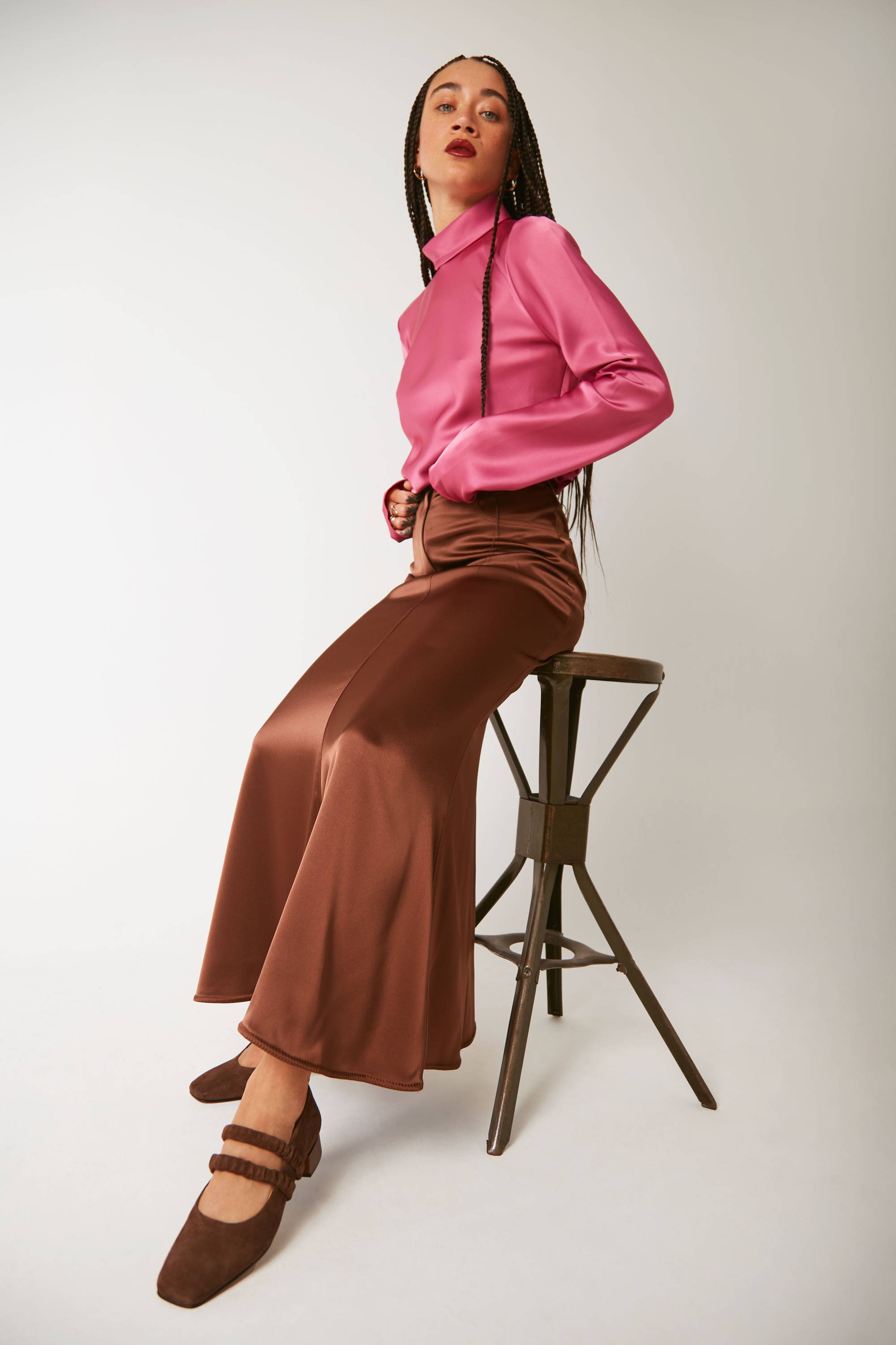 Vandrelaar Ruth Pump in brown suede styled on model with satin brown midi skirt and a satin long-sleeve fuschia hot pink turtle neck blouse
