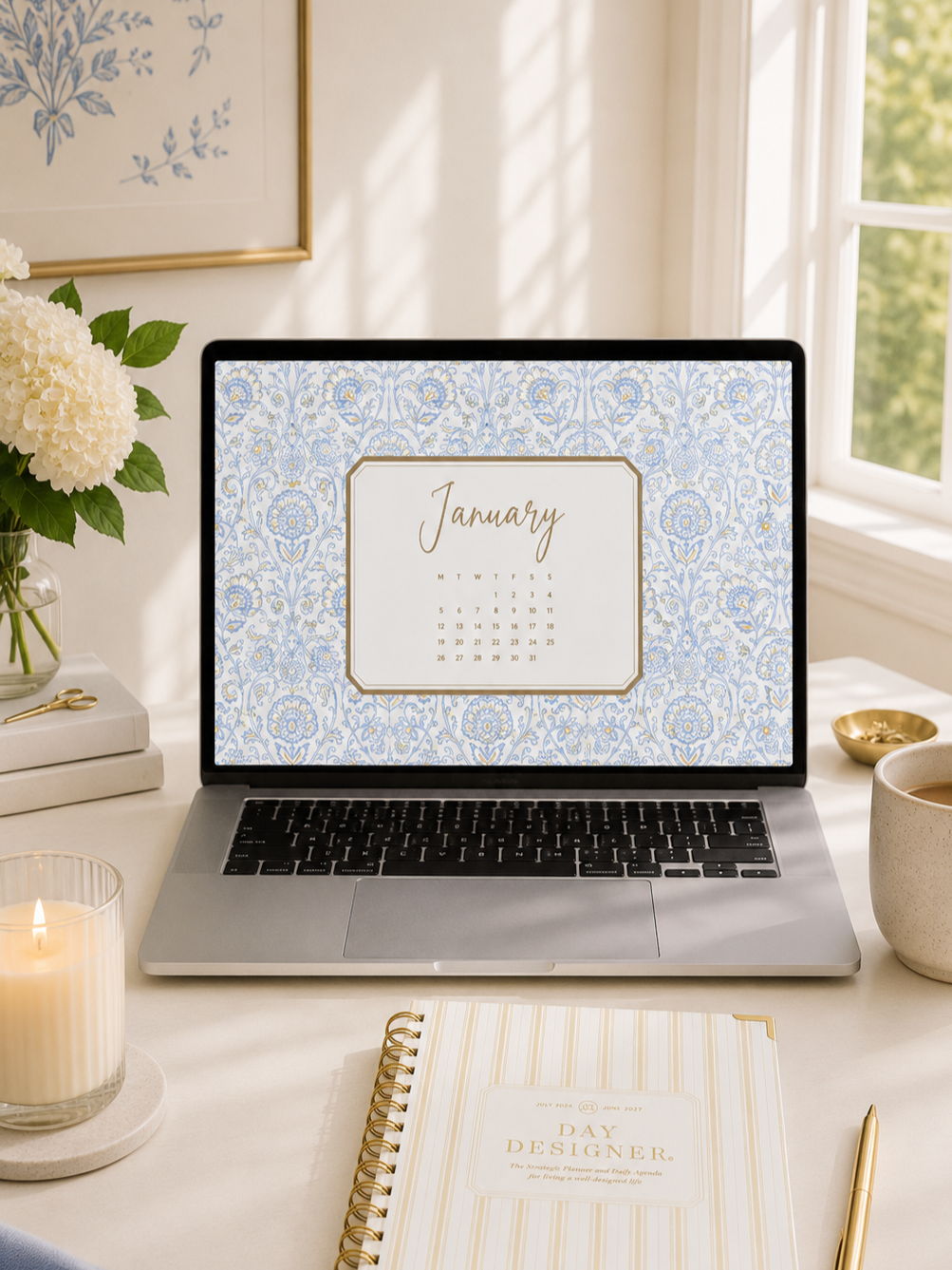 january 2026 digital wallpaper, repeated blue pattern shown on laptop, day designer planner, pen, candle, flowers in vase, picture, window, coffee