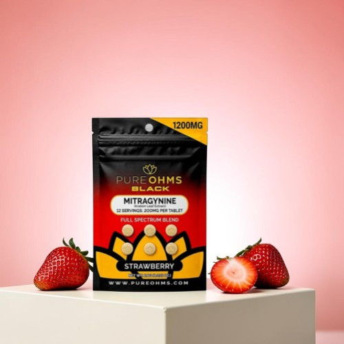 Black packaging of dietary supplement with strawberries on a pink background.