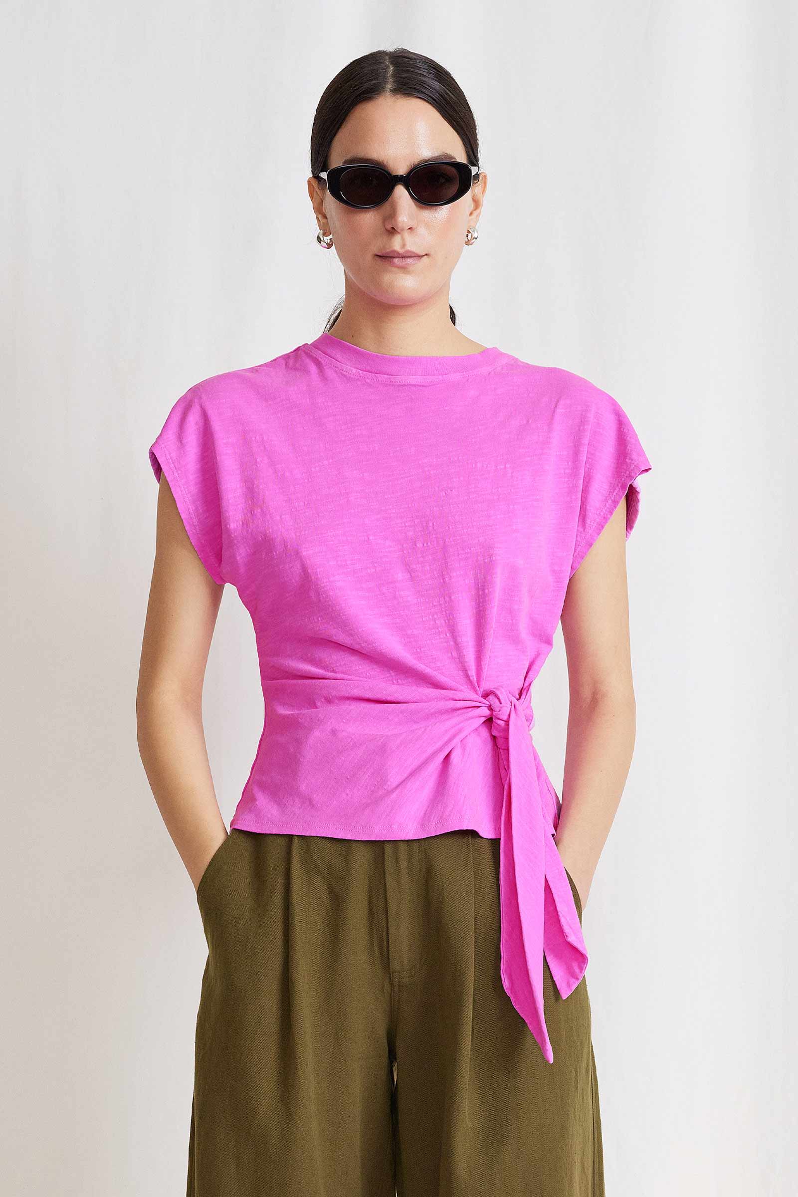 A lookbook image of a model wearing the Apiece Apart Nina Cinched Top Fuchsia.