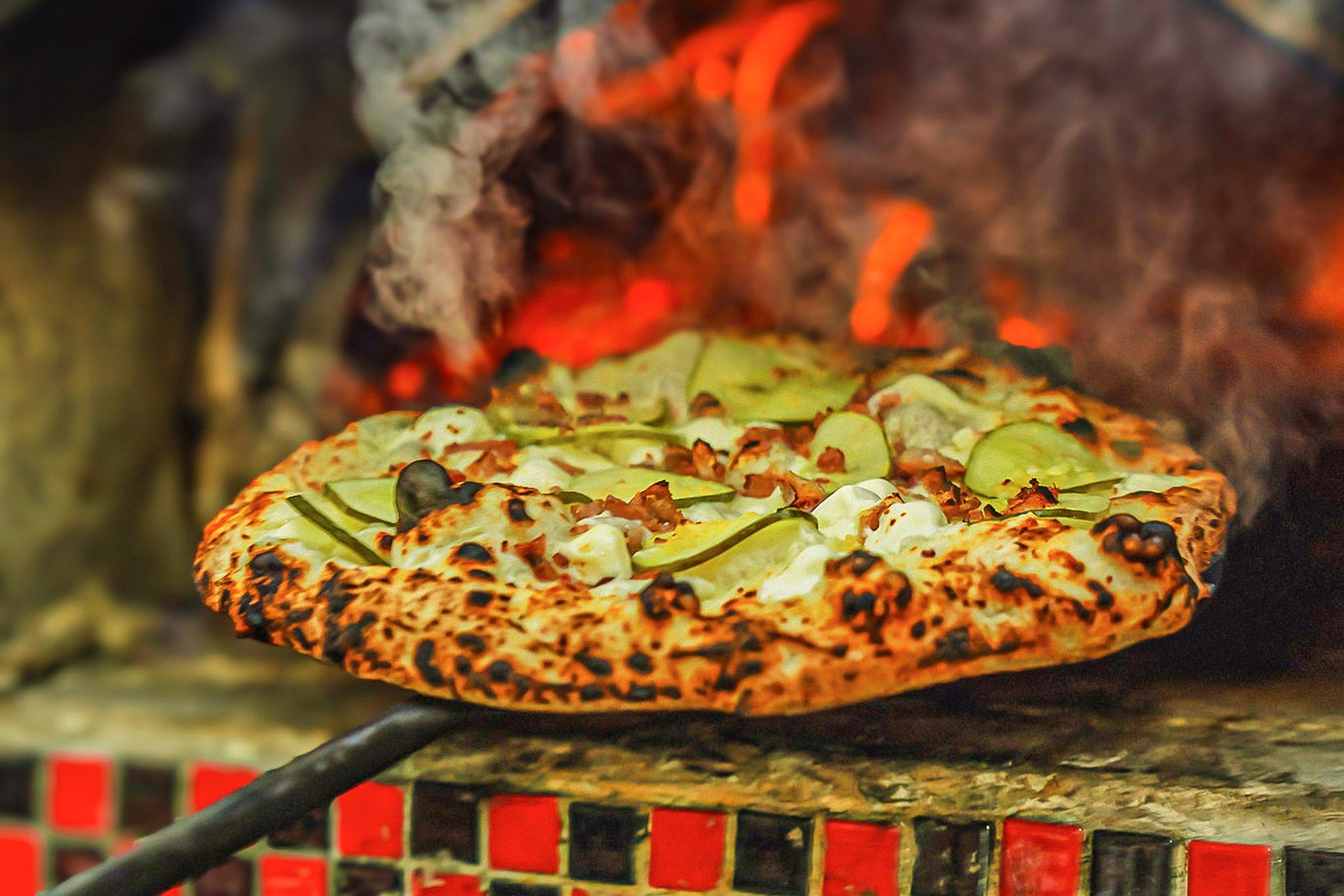 Wood-fired pickle pizza from Frank's Pizza and Pasta, reviewed by Dave Portnoy on One Bite Pizza Reviews and a One Bite Pizza Festival vendor, served fresh from the oven at The Big Dill pickle festival, Power Plant Live!, Baltimore Maryland 2024.