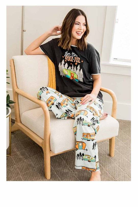 woman seated in chair wearing regular fit camper themed pajama shirt and pants