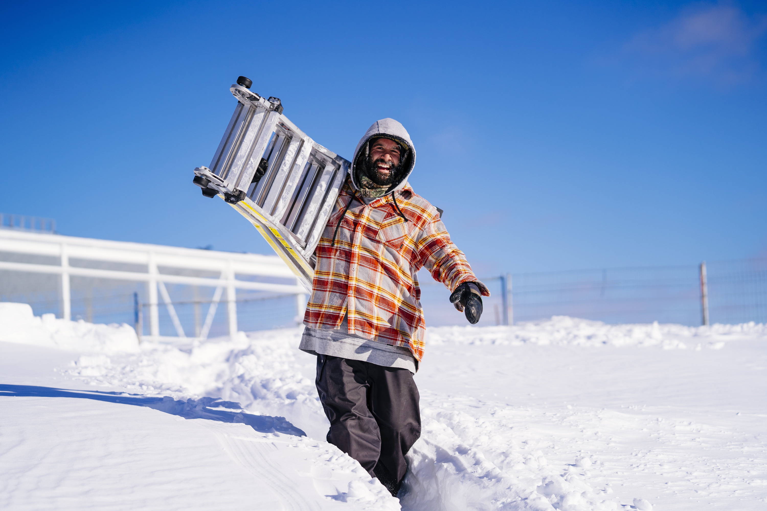 Frank April carrying ladder