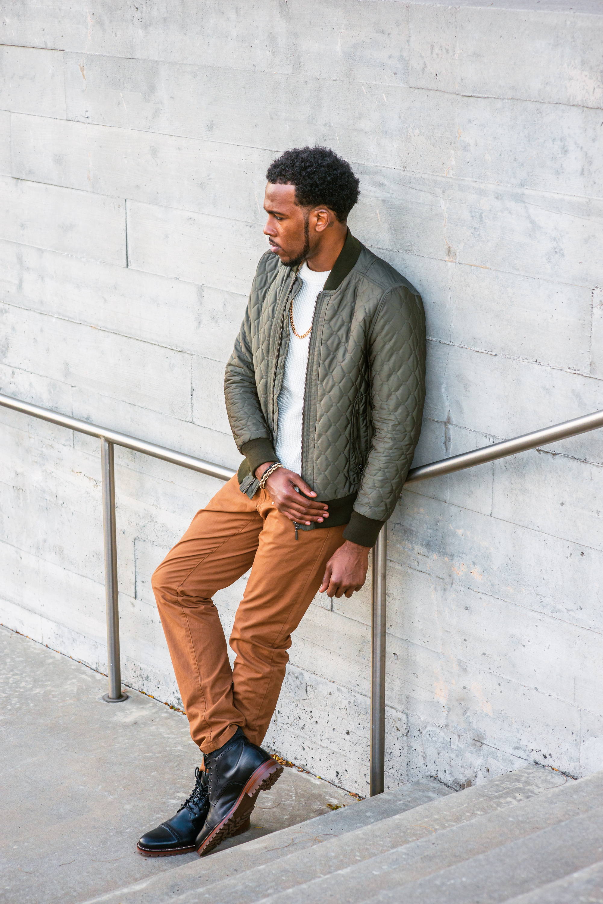 Stylish man leaning on railing