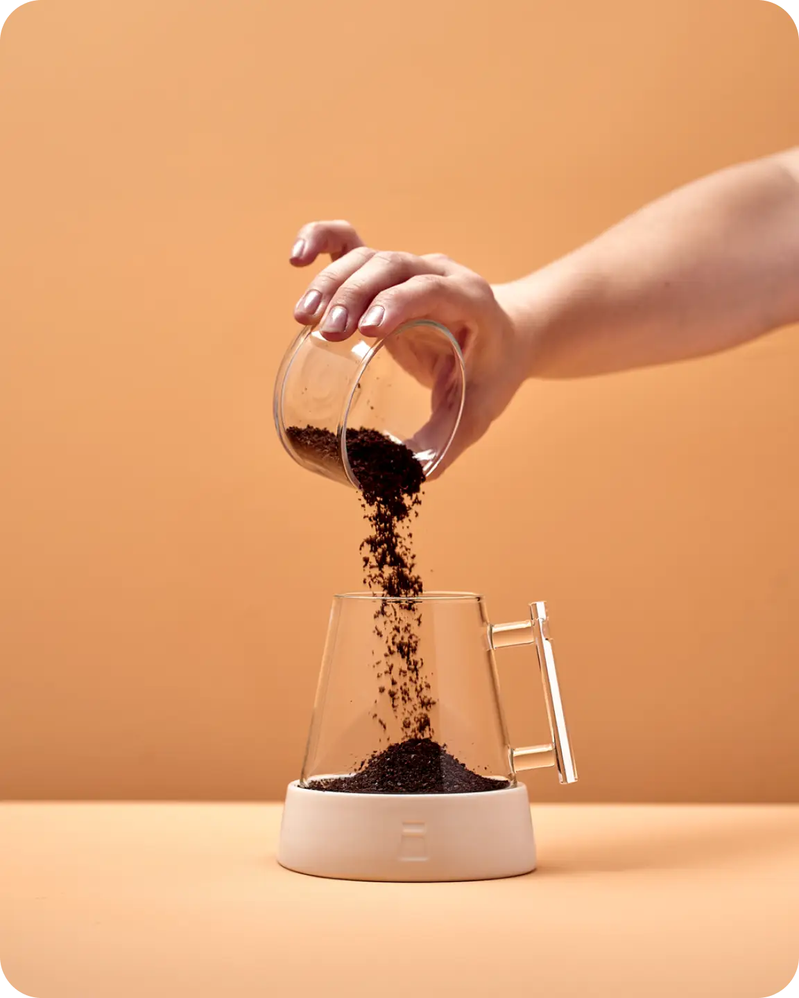 Coffee grounds pouring into the Pure Over glass dripper