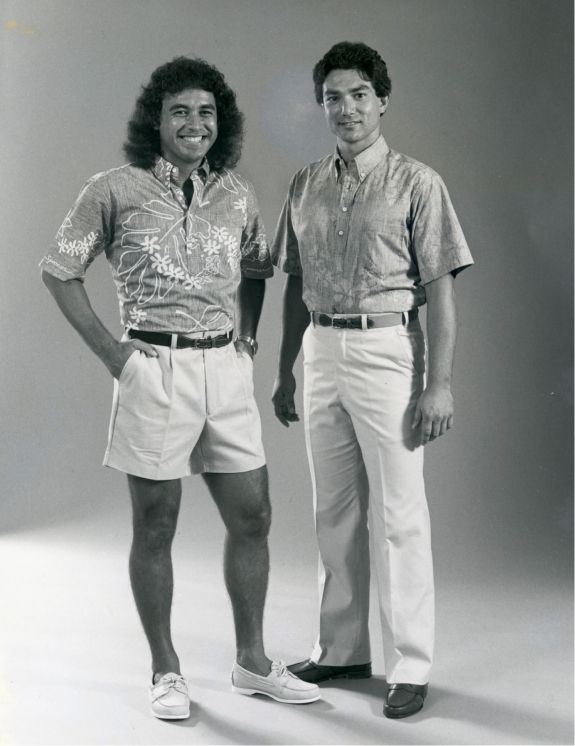Two men in stylish shirts and shorts, posing against a neutral background.