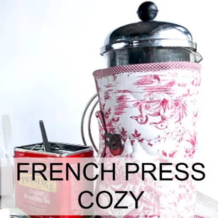 A cozy made to protect a french press an keep the thee hot