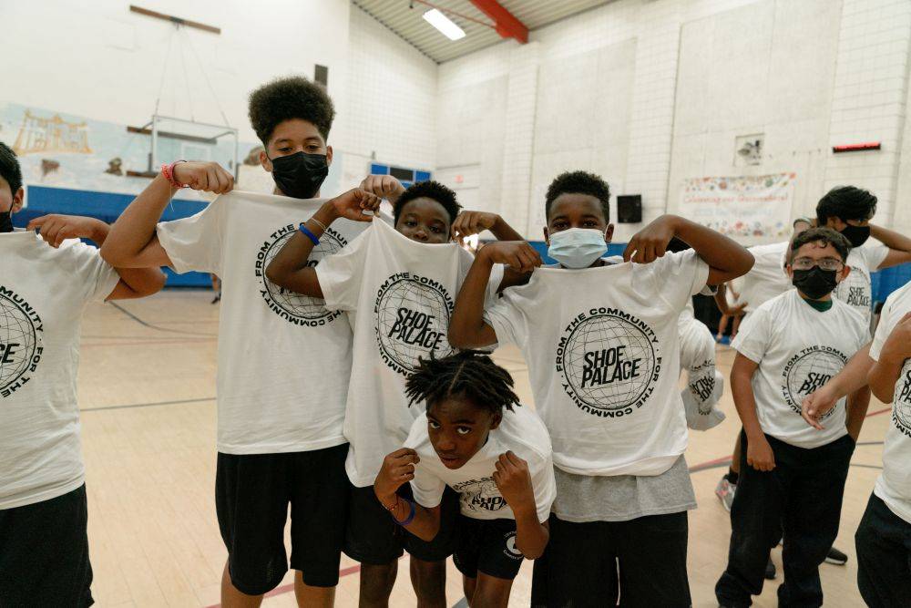 kids holding up their sp shirts