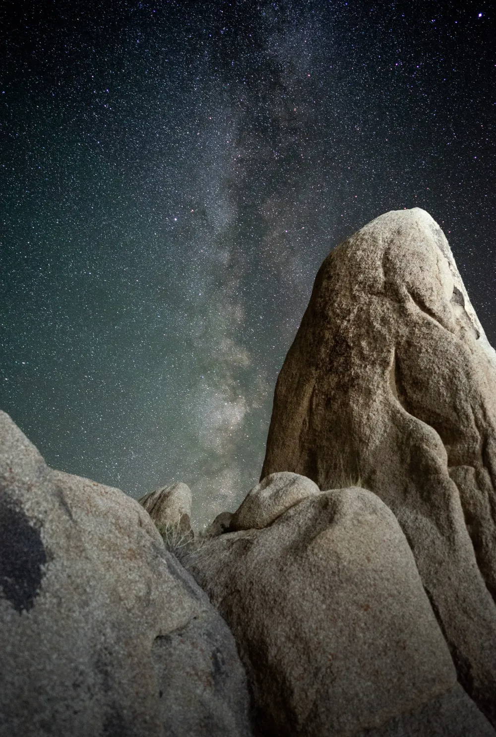 Rock formation at Joshua Tree under a starry night sky