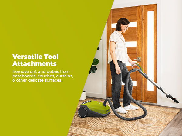 Person vacuuming with versatile tool attachments in a home setting.
