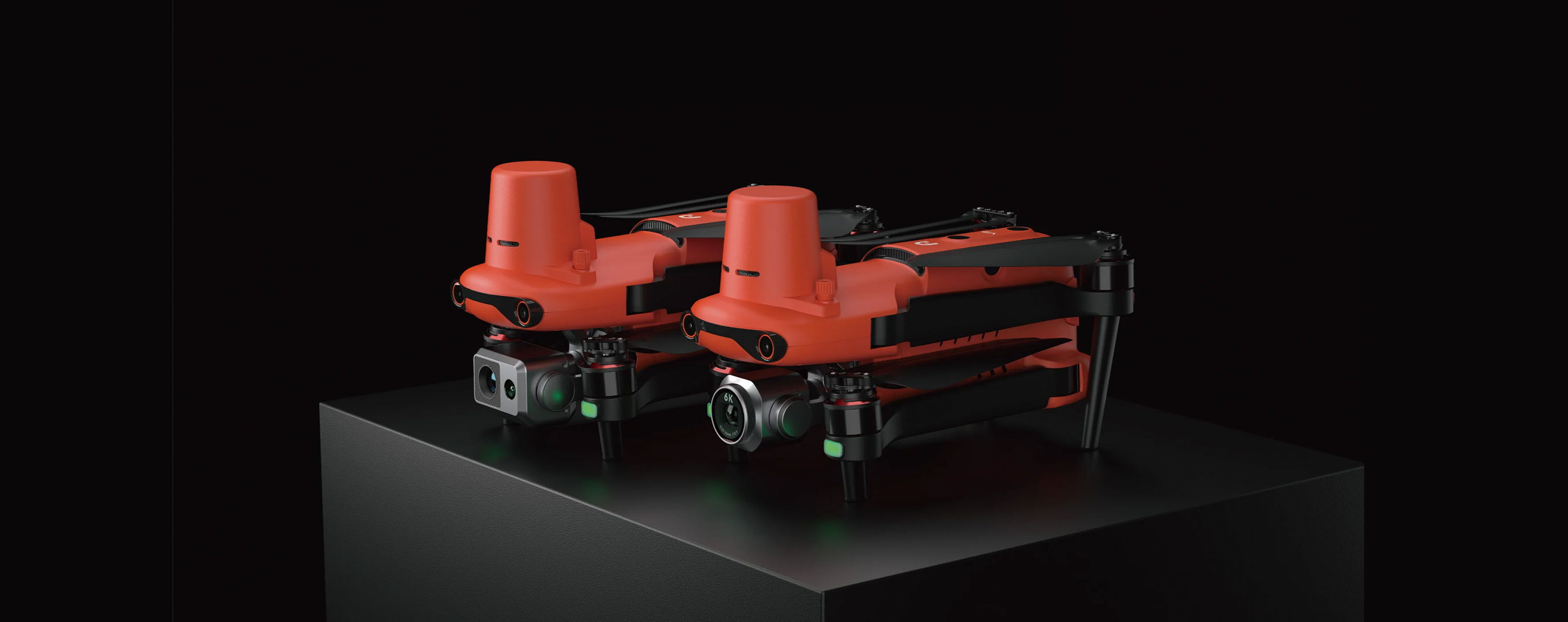 Two Autel EVO II drones on a black display pedestal.